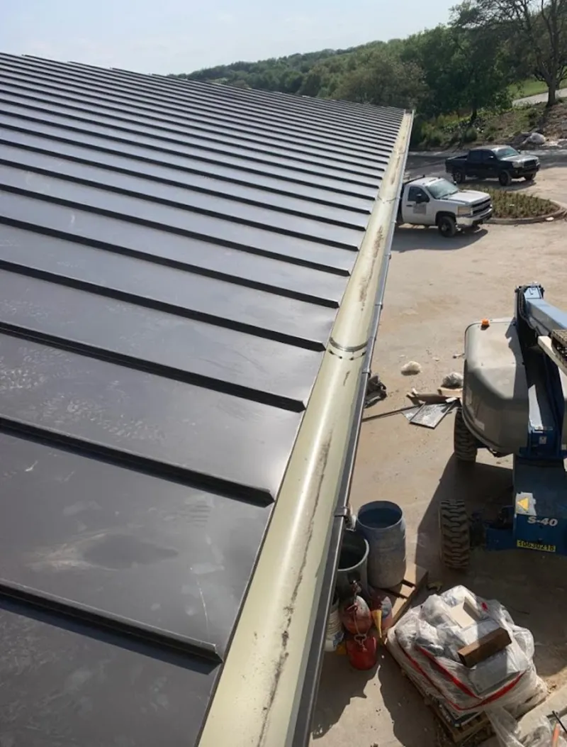 Standing seam panel and gutter detail on a metal roofing jobsite in Airway Heights